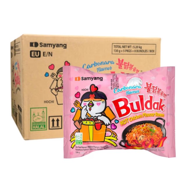 Samyang Buldak Carbonara ramen packet in front of its shipping carton showing case configuration